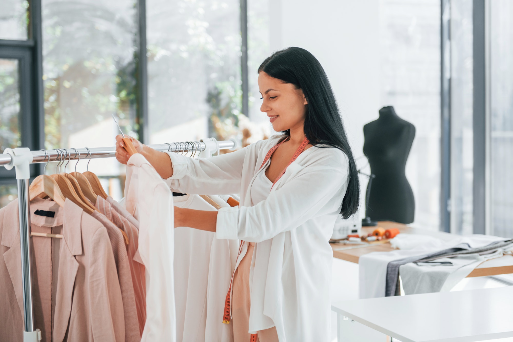 Taking clothes. Seamstress is in her office at daytime